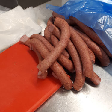 Hand-cut sausages, after the smoking process